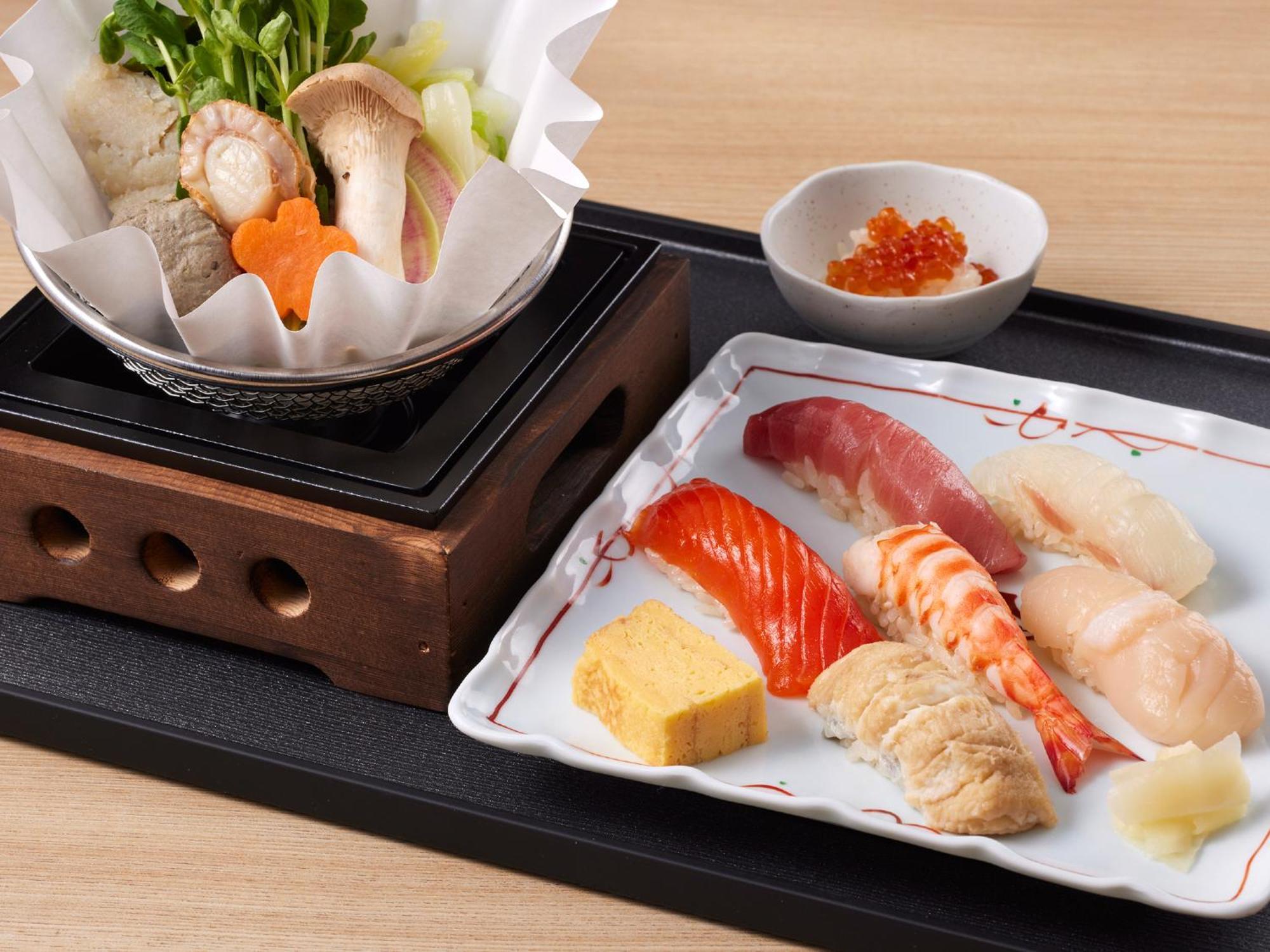 Grand Nikko Tokyo Bay Maihama Hotel Urayasu Екстериор снимка The photo features a Japanese meal presented on a wooden tray. On the left, there is a small pot with a clear broth containing vegetables, mushrooms, and possibly meat, indicated by green herbs and a piece shaped like a flower. On the right, there is